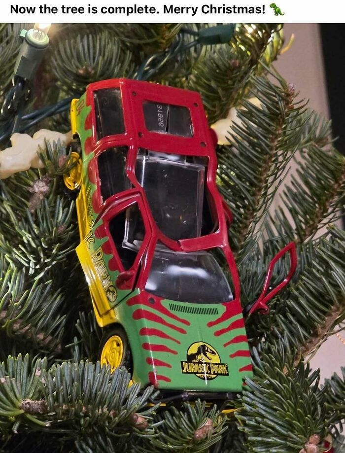Jurassic Park toy car used as a Christmas tree ornament on a pine branch