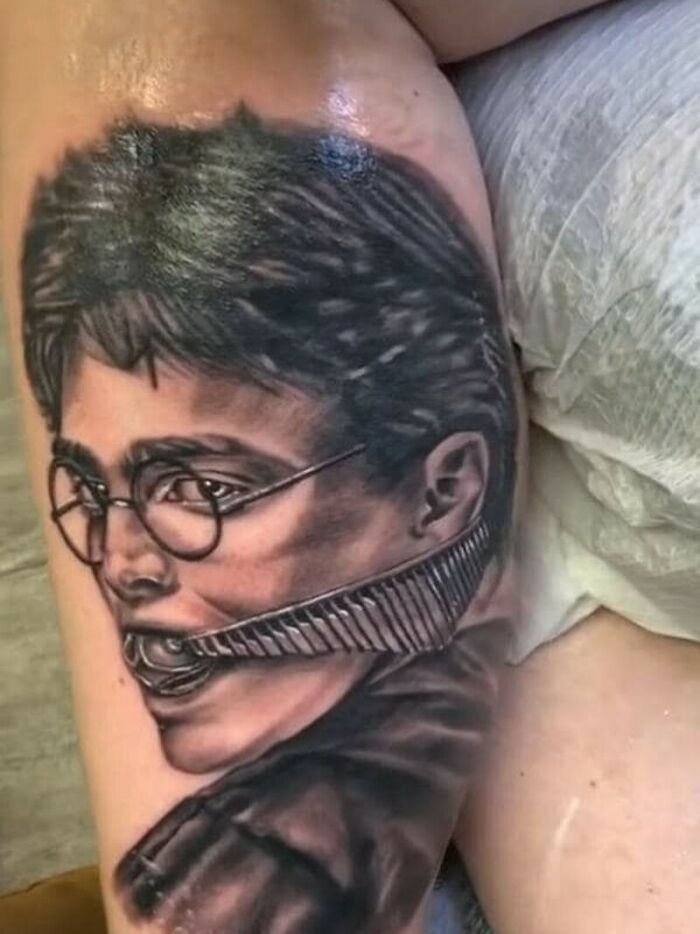 A black and white Harry Potter tattoo featuring a comb in his mouth, an example of questionable tattoo ideas.