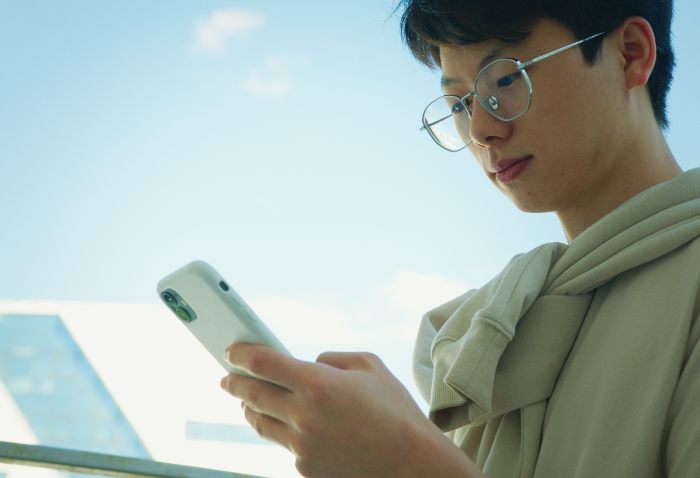 A Gen Z boy engaged with his phone, potentially on viral dopamine sites, highlighting the new trend. A Gen Z boy engaged with his phone, potentially on viral dopamine sites, highlighting the new trend.