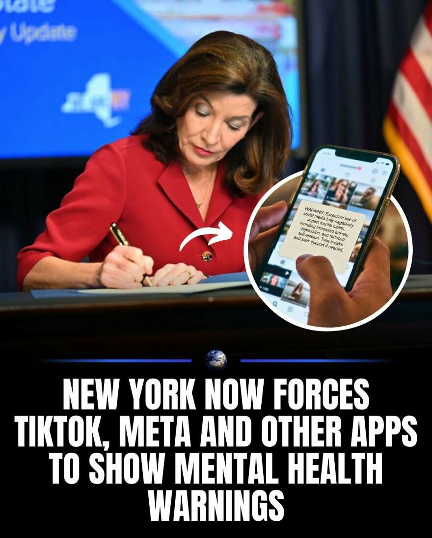 A person holding a phone displays a mental health warning from a social media app, reflecting global humanity and our planet's well-being.