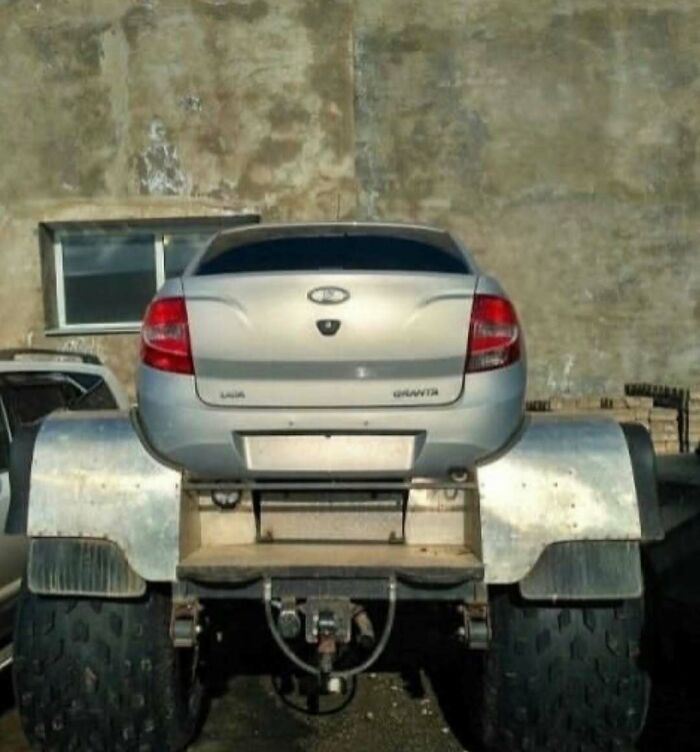 Cursed image of a car body mounted on oversized wheels