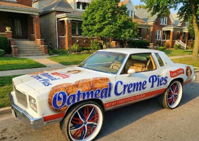 Car painted with Little Debbie Oatmeal Creme Pies design parked in a residential area