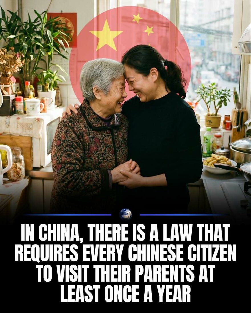 An elderly Chinese woman and a younger woman embracing in a kitchen, representing humanity and family.