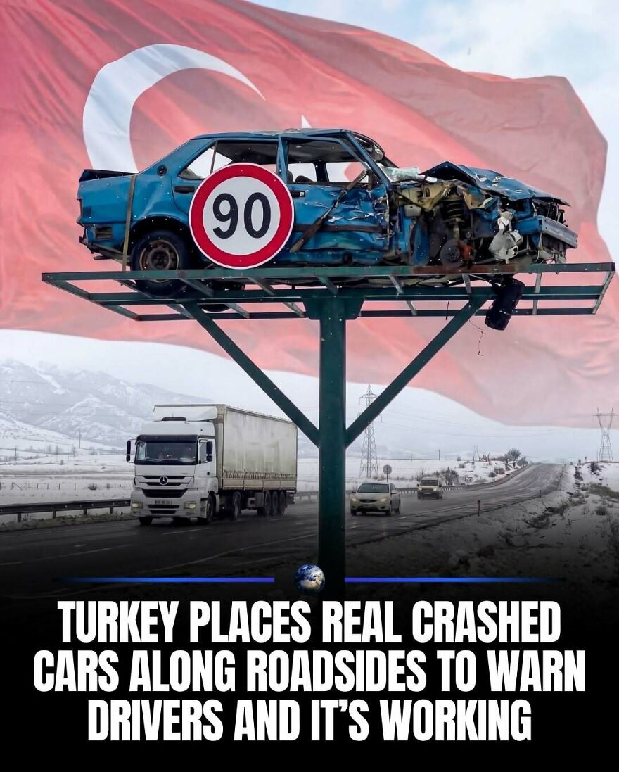 A crashed car on a billboard in front of a Turkish flag, highlighting humanity and safety.