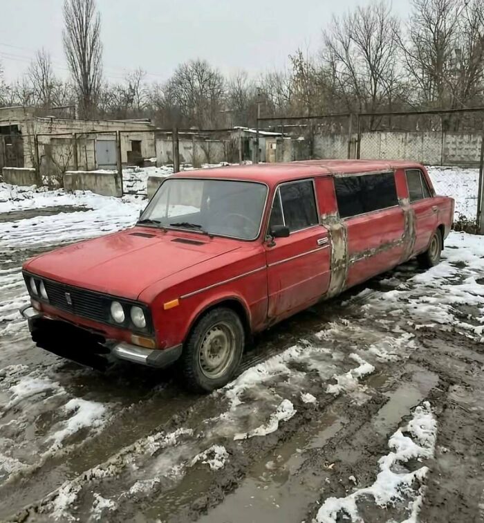Red old car modified into a stretched limousine parked on muddy snowy ground cursed images