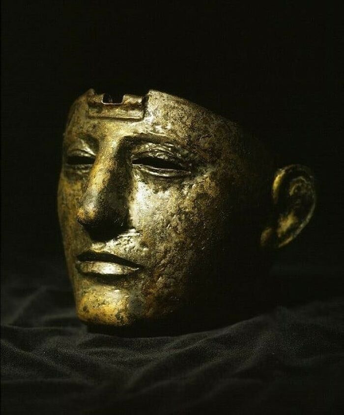 Ancient golden mask historical treasure with detailed facial features