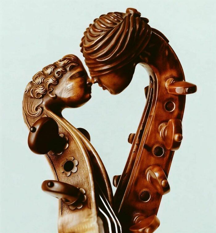 Intricately carved wooden violin scroll with two faces historical treasure