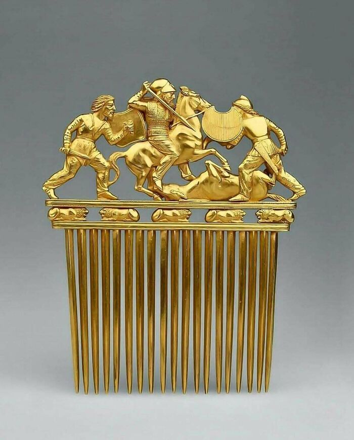 Ornate gold comb depicting warriors in battle historical treasure