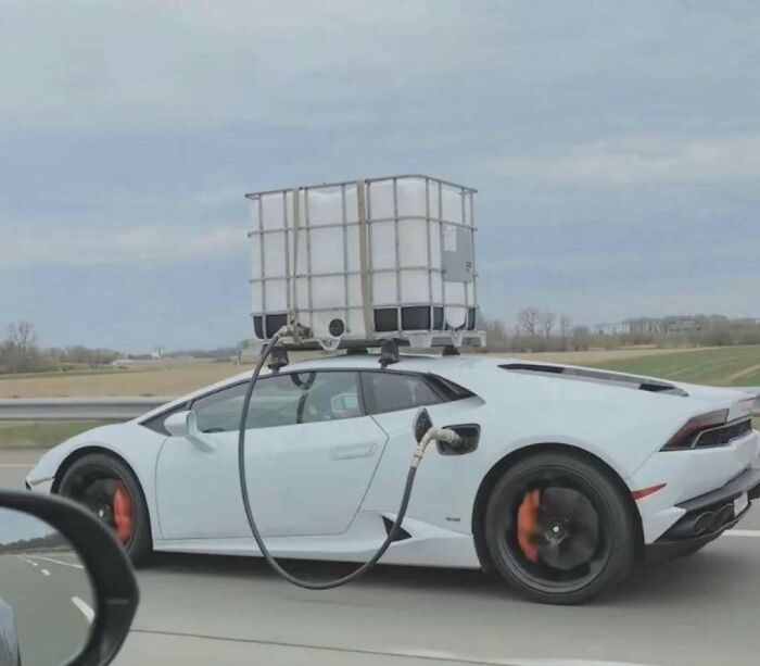 White sports car with large water container and hoses attached in cursed image