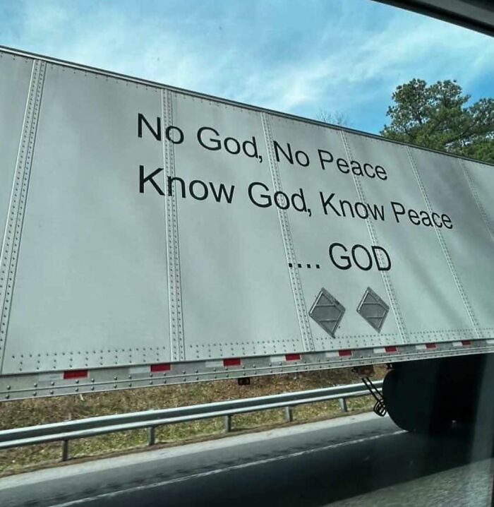 Side of a truck with the cursed quote about God and peace printed