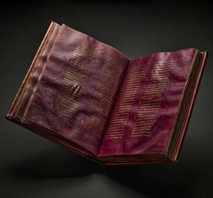 Ancient purple manuscript historical treasure book with gold writing