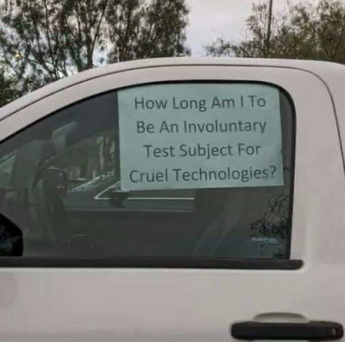 Sign on car window asking about being an involuntary test subject for cruel technologies