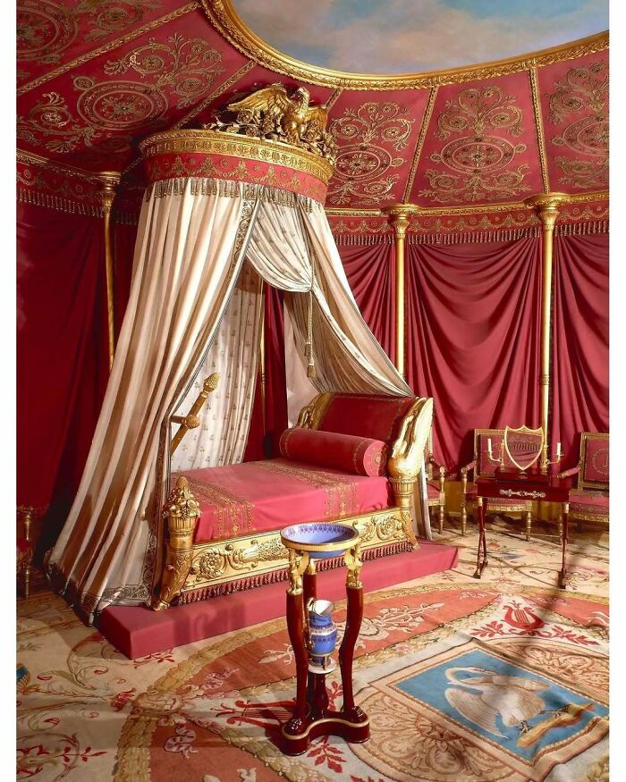 Luxurious historical treasure canopy bed with red and gold decor