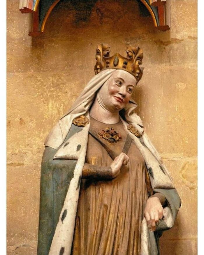 Medieval statue of crowned queen in regal attire historical treasure