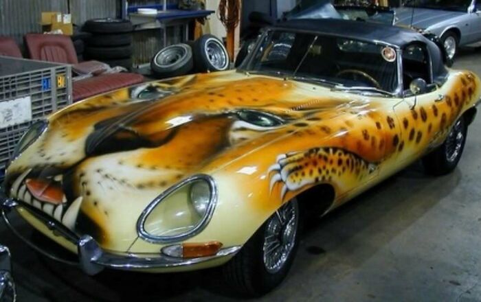 Car with detailed cheetah face airbrush paint design