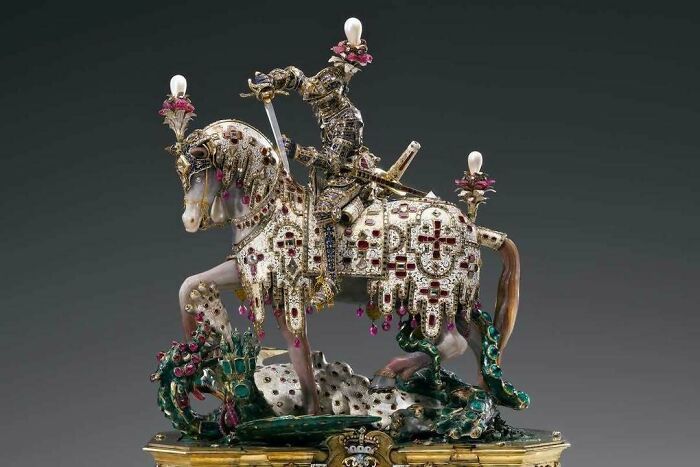 Ornate historical knight statue on horse decorated with jewels and gold