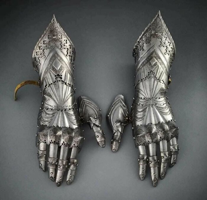Pair of intricately designed medieval steel gauntlets with decorative etching