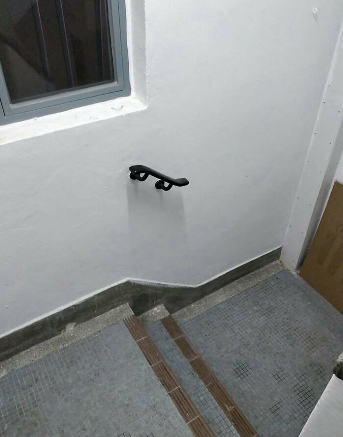 Strange stair handrail design on white wall in cursed images