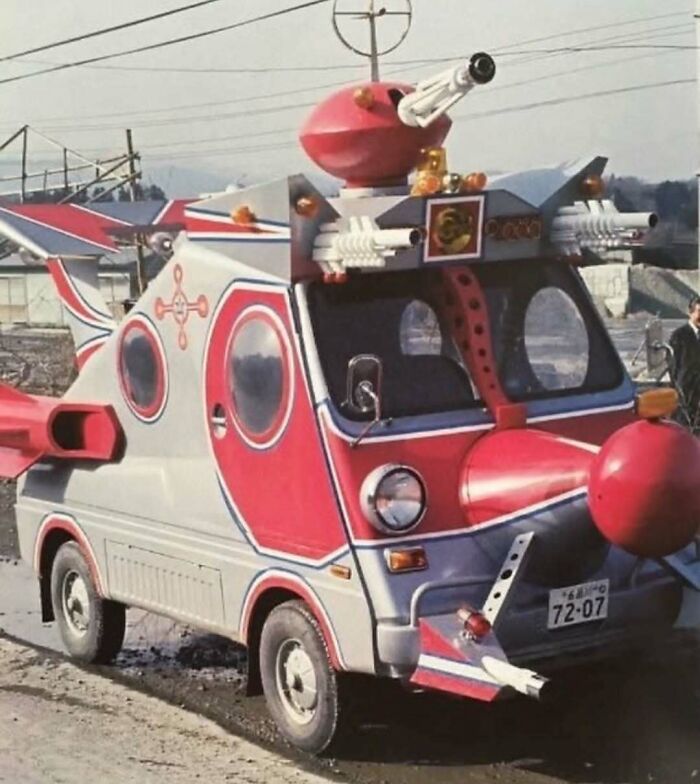Unusual small red and silver vehicle with multiple fake guns and big red nose attachment