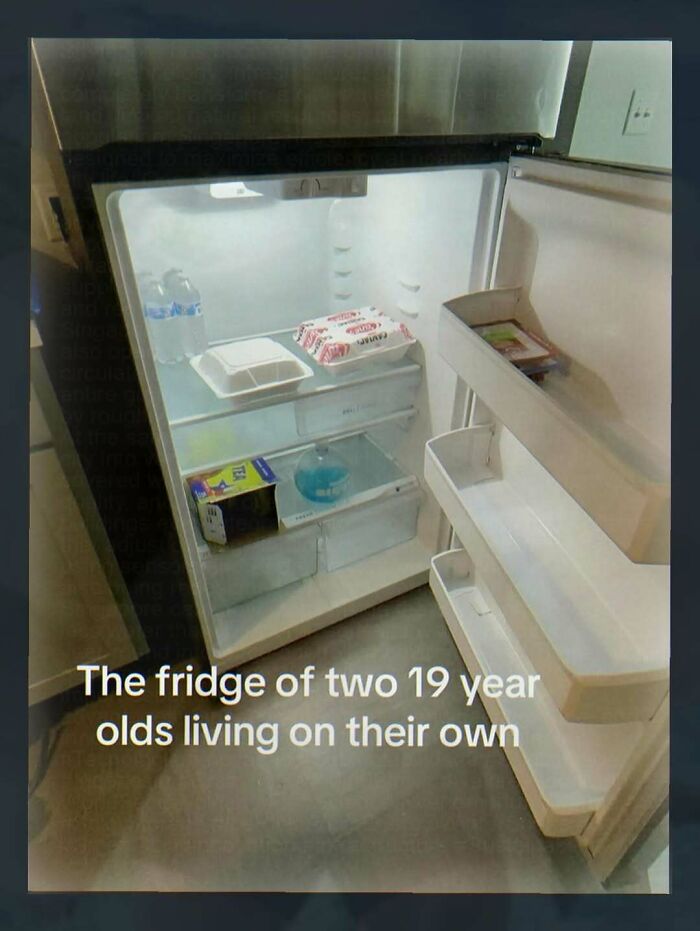 An almost empty refrigerator with only a few items inside, illustrating the Chaotic and Unhinged Pics of young adults living alone.