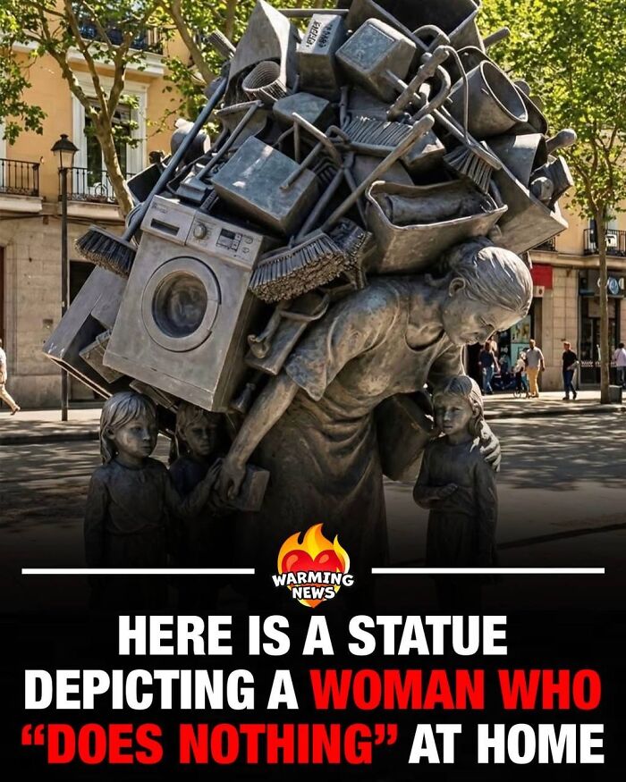 A statue depicting a woman carrying household items and children, a soul-healing representation of work.
