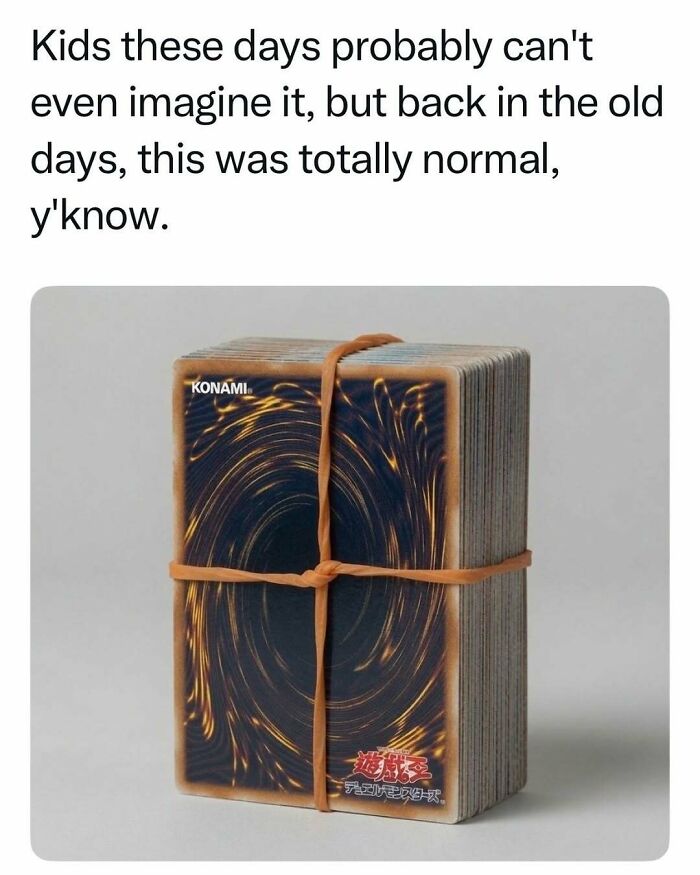 Stack of Yu-Gi-Oh trading cards tied with a rubber band representing nostalgic childhood games