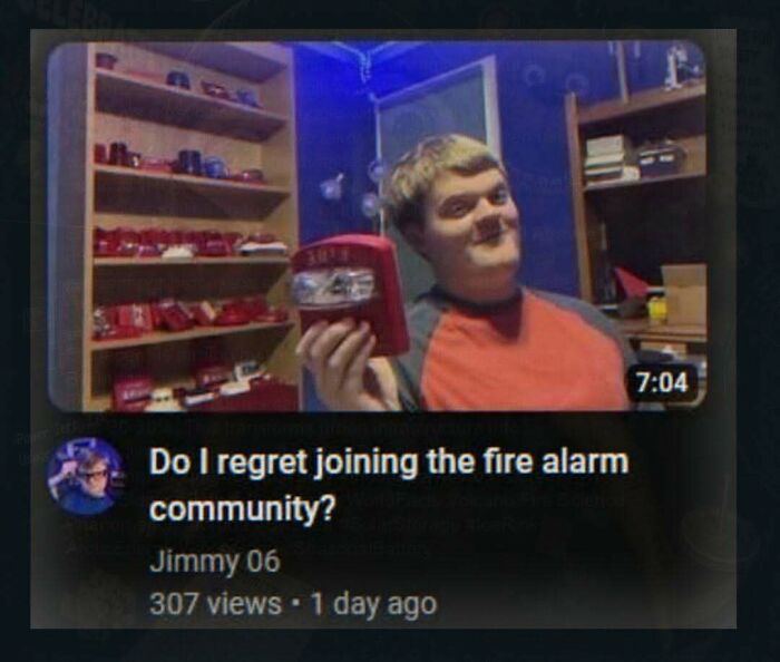 An unhinged pic from a YouTube video showing a young man with fire alarms on shelves, discussing the fire alarm community.