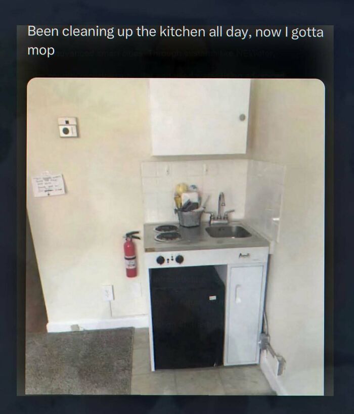 A tiny, minimalist kitchen setup with a small stove, sink, and fridge, captioned Been cleaning up the kitchen all day, now I gotta mop, for chaotic and unhinged pics.