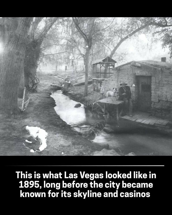 A rare historical photo of Las Vegas in 1895, showing a stream and a man with a dog near a rustic building.