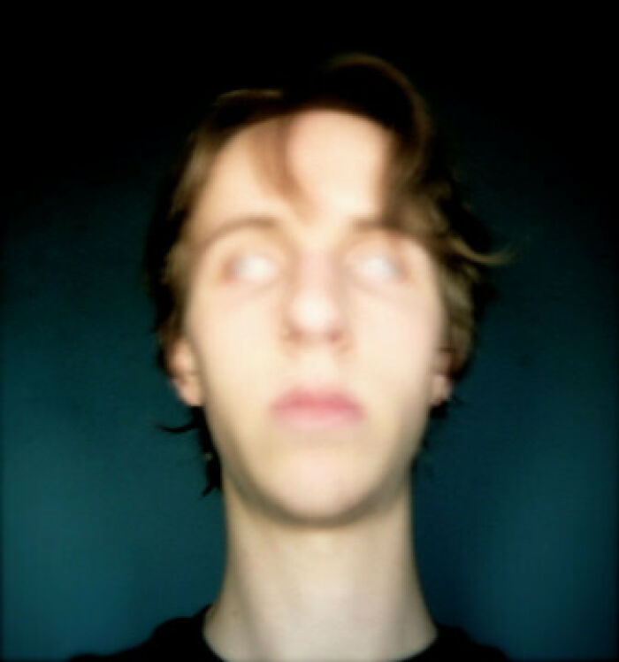 Blurry portrait with white eyes creating a creepy photo effect