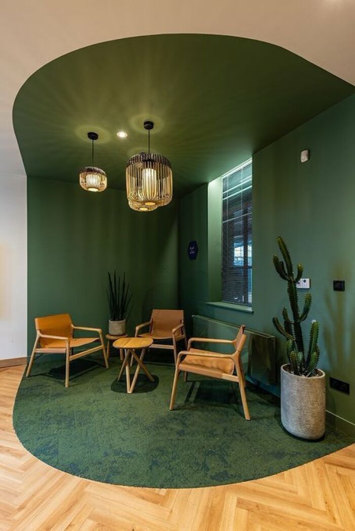 Modern green interior design corner with chairs and pendant lights