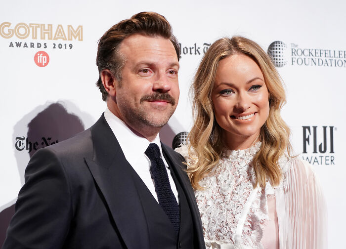 Jason Sudeikis and co-star smiling at a red carpet event Jason Sudeikis and co-star smiling at a red carpet event