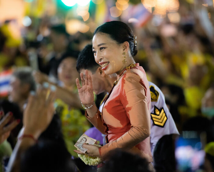 Thai princess waving to crowd during public event wearing traditional attire Thai princess waving to crowd during public event wearing traditional attire