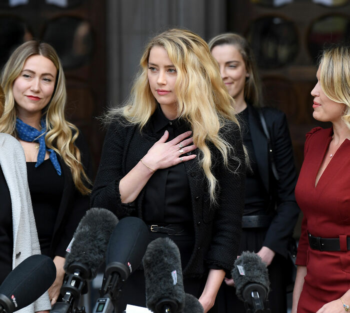 Amber Heard at a press conference, before her move to a new country and new life, changing her name. Amber Heard at a press conference, before her move to a new country and new life, changing her name.
