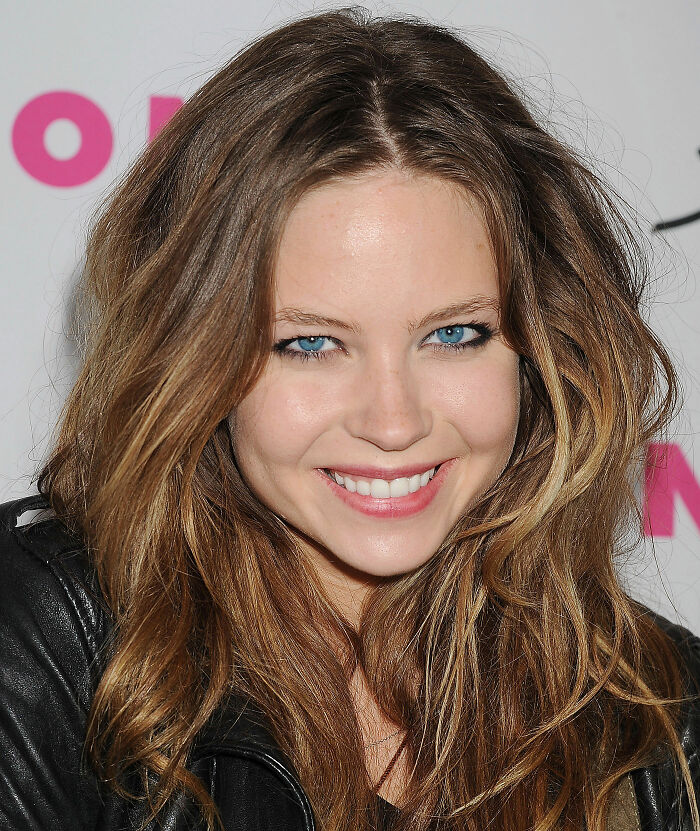 Actress Daveigh Chase smiling with bright blue eyes, long brown hair, and a black leather jacket. Actress Daveigh Chase smiling with bright blue eyes, long brown hair, and a black leather jacket.