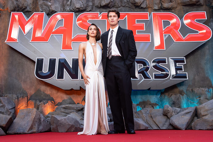 Actors posing at Masters Of The Universe premiere with logo backdrop Actors posing at Masters Of The Universe premiere with logo backdrop