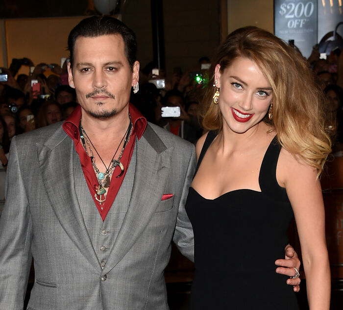 Amber Heard with Johnny Depp at an event, before fleeing Hollywood to a new country and new life. Amber Heard with Johnny Depp at an event, before fleeing Hollywood to a new country and new life.
