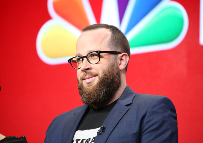 Amazon executive speaking at event behind NBC logo Amazon executive speaking at event behind NBC logo