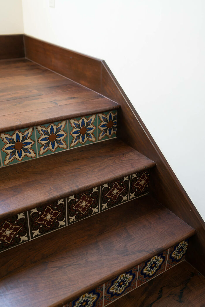 Wooden stairs with colorful patterned tile interior design details