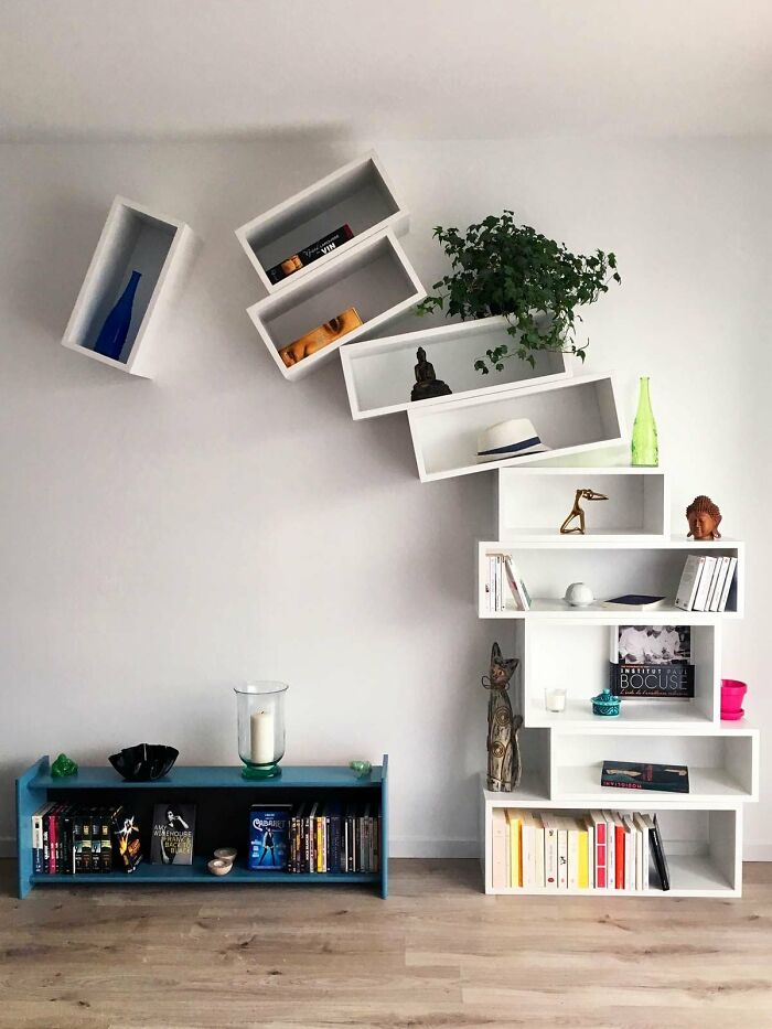 Tilted white shelves and modern plant display as interior design ideas