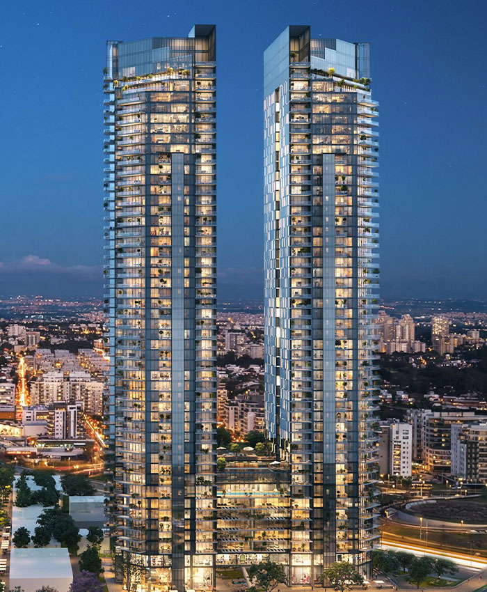 Modern residential skyscrapers lit at night in cityscape Modern residential skyscrapers lit at night in cityscape