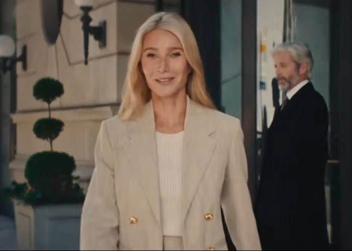Blonde woman smiling in beige blazer outside a building Blonde woman smiling in beige blazer outside a building