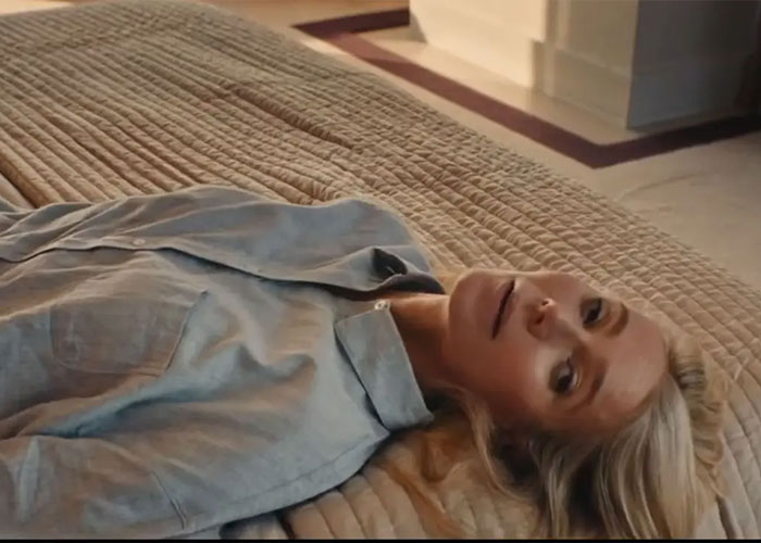 Woman lying on bed in a casual shirt scene from Colin Firth's ex-wife controversy Woman lying on bed in a casual shirt scene from Colin Firth's ex-wife controversy