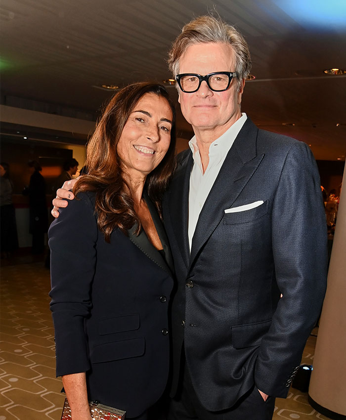 Couple posing together at an event with man in a suit Couple posing together at an event with man in a suit