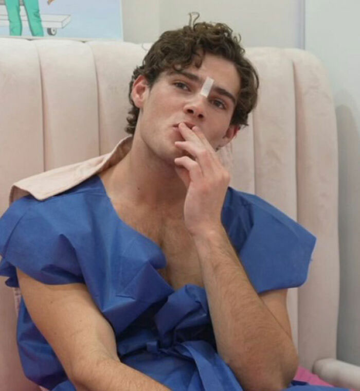 Looksmaxxer Clavicular sitting in medical gown with facial bandage
