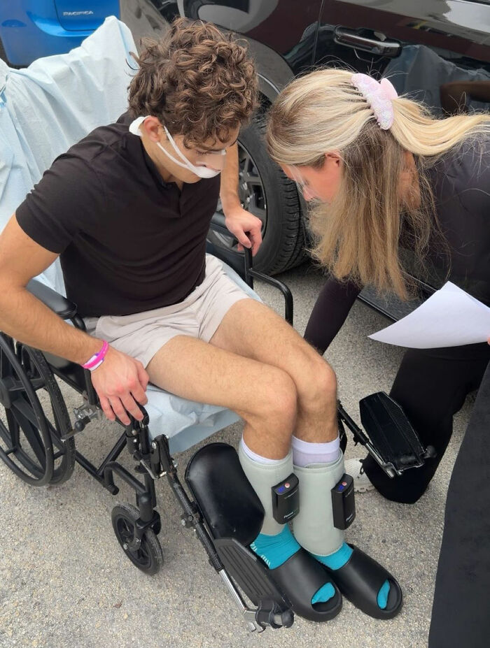 Man in wheelchair wearing leg braces during post-surgery recovery looksmaxxer clavicular