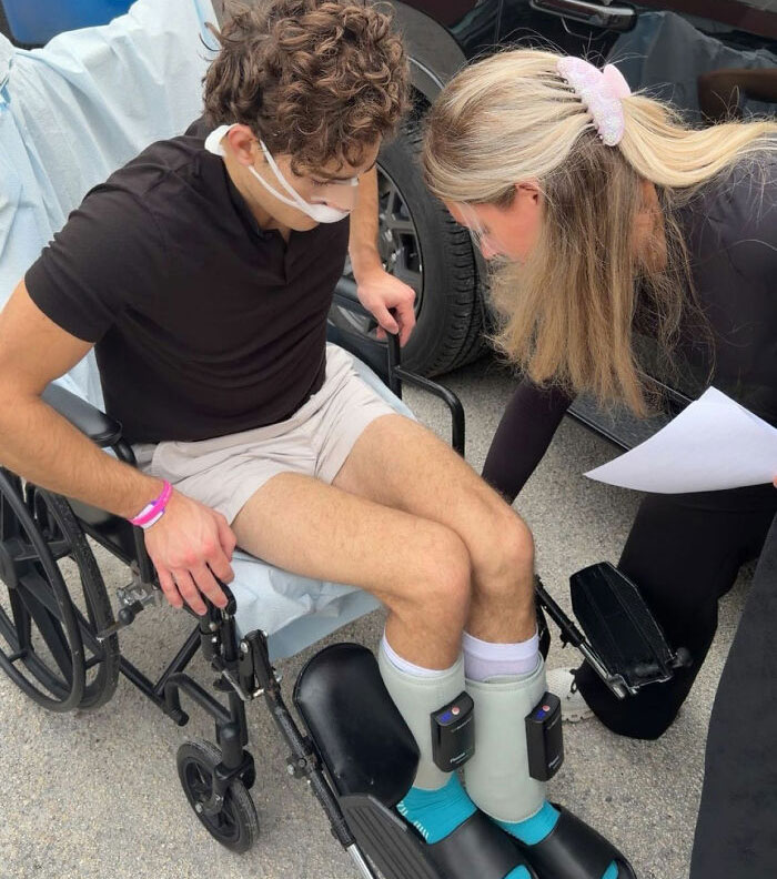 Looksmaxxer in wheelchair after surgery with leg braces and mask
