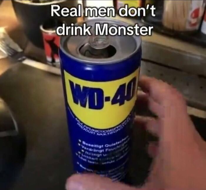 A cringe image showing a person holding an open can of WD-40, implying it is a drink for real men.