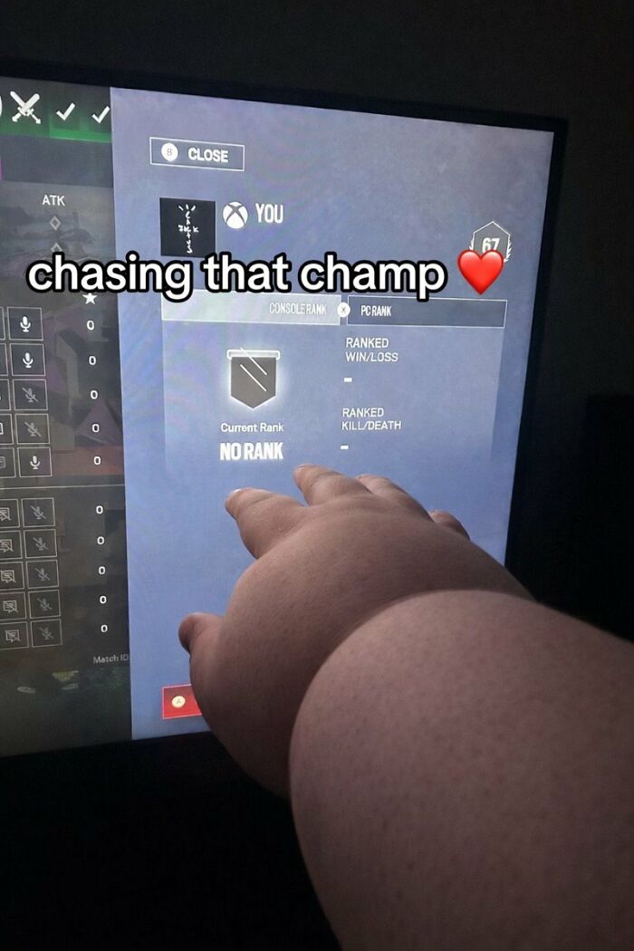 A cringe image of a person's hand pointing at a gaming screen showing No Rank, humorously failing to achieve champ.