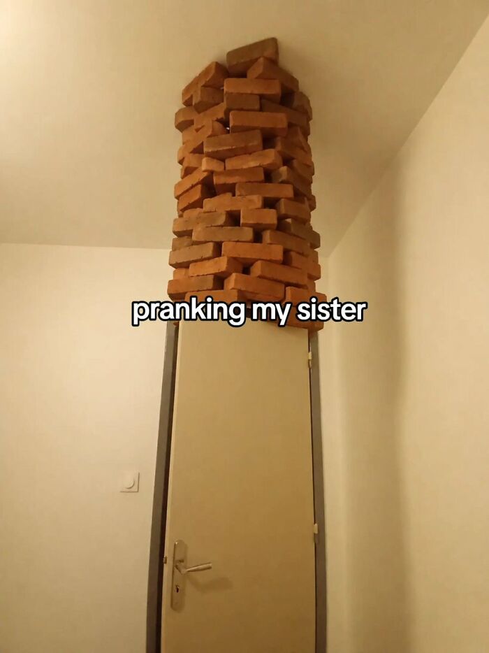 A cringe image showing a prank where bricks are stacked above a door, set to fall on someone.